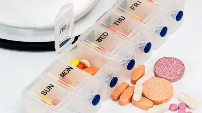 A weekly pill organizer with assorted tablets
