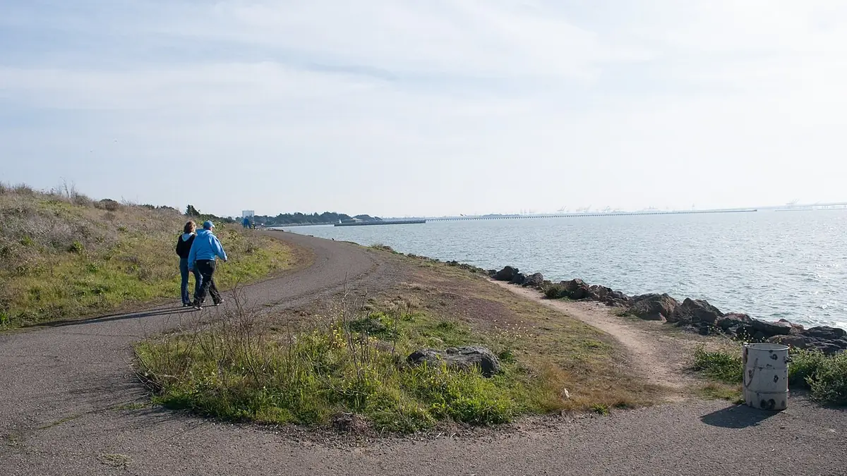People walking along a lakeside path